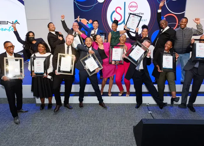 Award winners celebrating on stage at Business Day Supplier Development Awards, organised by Catherine