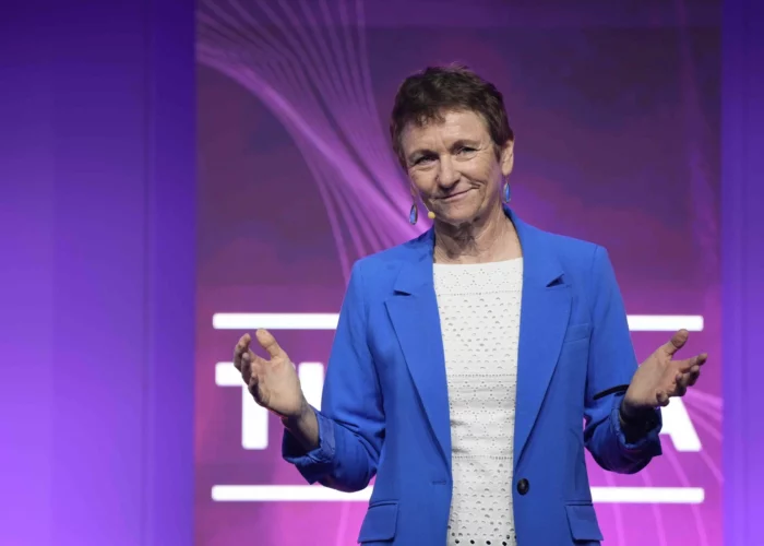 Catherine Wijnberg delivering a keynote on stage with a purple backdrop at UK KTN Women Innovators event